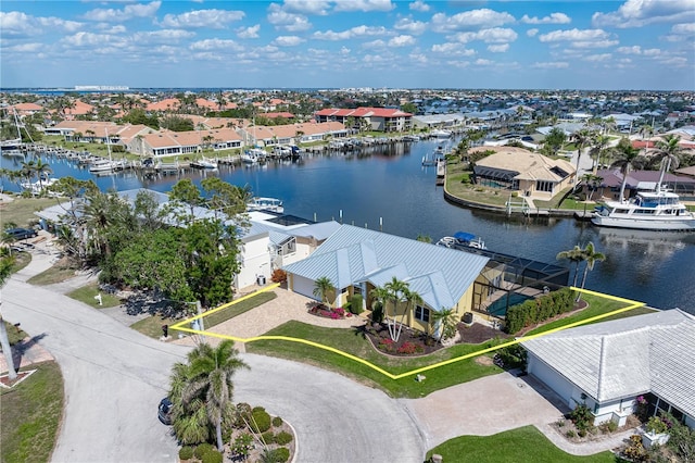 bird's eye view featuring a water view and a residential view