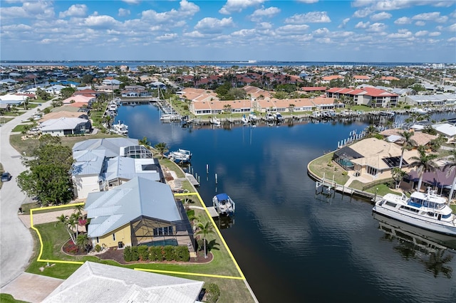 birds eye view of property with a water view and a residential view