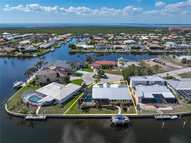 drone / aerial view with a water view and a residential view