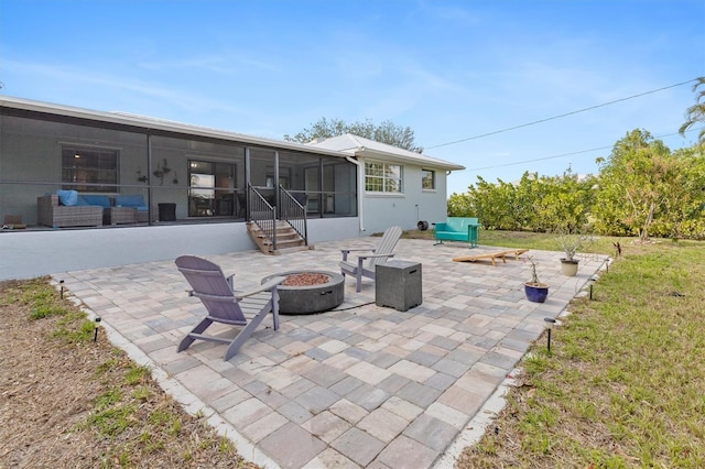 view of patio with a fire pit and a sunroom