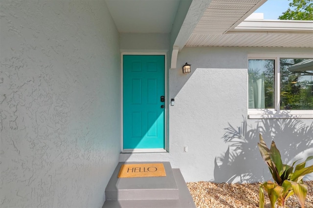 entrance to property with stucco siding