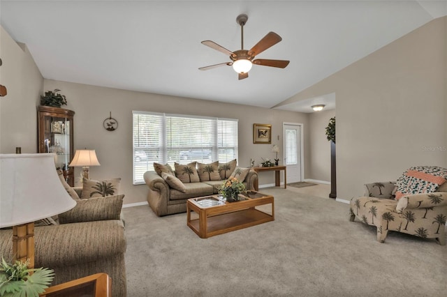 living room featuring lofted ceiling, carpet floors, ceiling fan, and baseboards