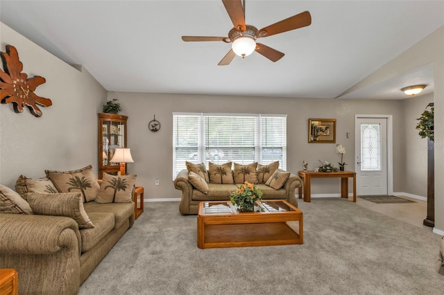 living room featuring lofted ceiling, carpet floors, and a healthy amount of sunlight