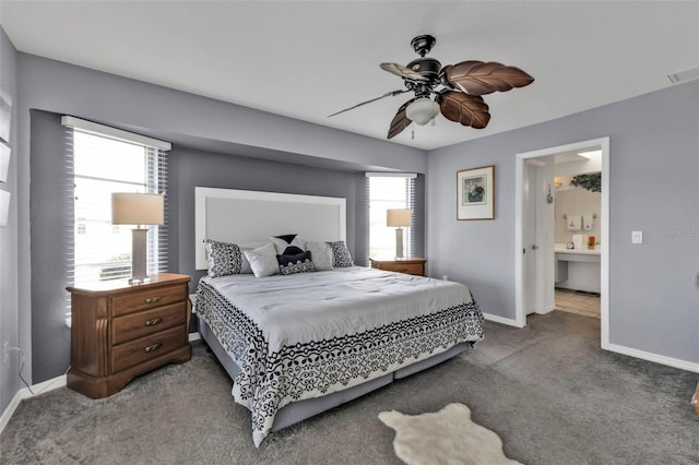 carpeted bedroom featuring visible vents, ensuite bathroom, a ceiling fan, and baseboards