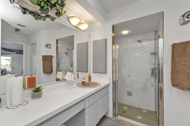 full bathroom featuring visible vents, a shower stall, and vanity