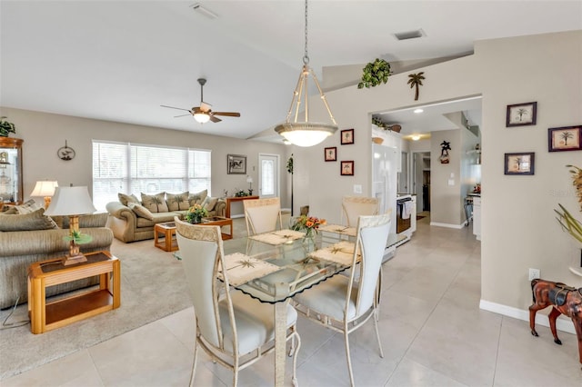 dining space with light tile patterned floors, vaulted ceiling, visible vents, and a ceiling fan