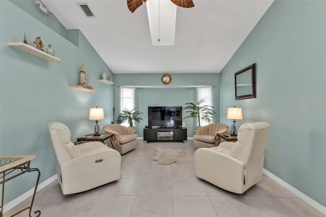 living area with lofted ceiling, tile patterned flooring, baseboards, and ceiling fan