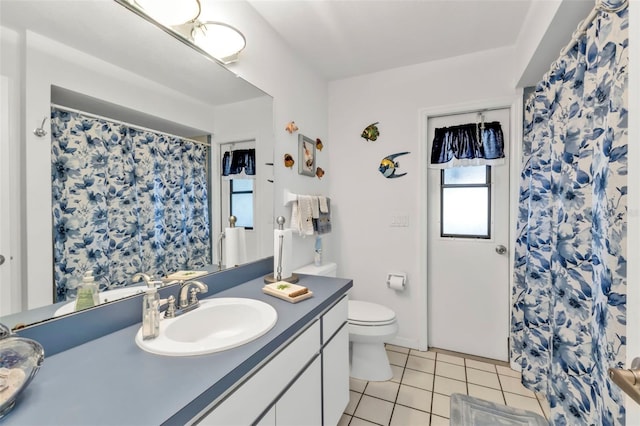 full bathroom with a shower with shower curtain, vanity, toilet, and tile patterned floors