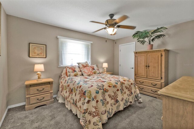 bedroom featuring baseboards, a ceiling fan, and light colored carpet