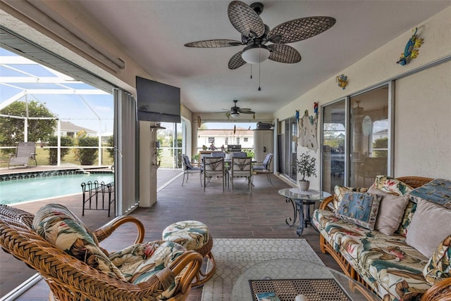 view of patio / terrace with an outdoor pool, a ceiling fan, glass enclosure, outdoor dining area, and outdoor lounge area