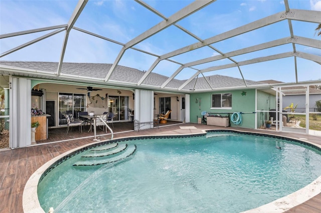 outdoor pool featuring ceiling fan, a patio, and a lanai