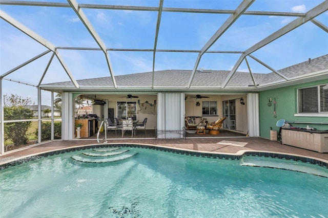 outdoor pool featuring a patio area, ceiling fan, and glass enclosure