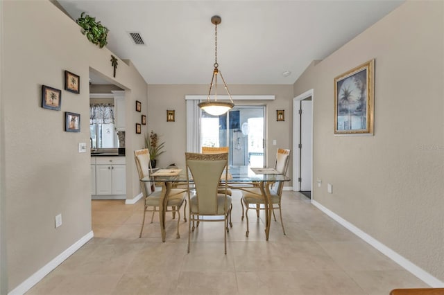 dining area featuring visible vents, baseboards, and light tile patterned floors