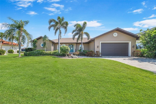 ranch-style house featuring a garage, decorative driveway, a front yard, and stucco siding