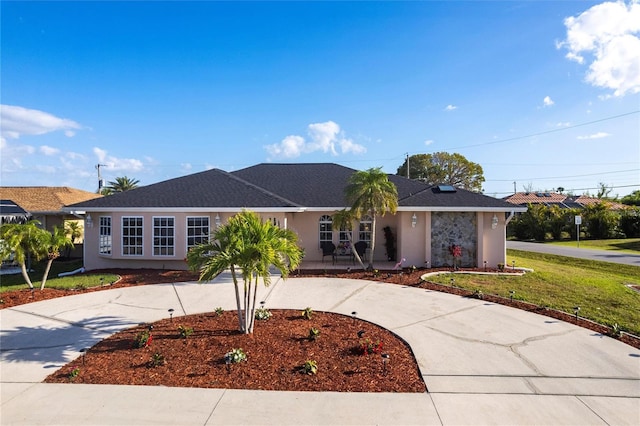 20339 Gentry Ave, Port Charlotte, FL 33952 - ranch-style house featuring curved driveway, a front lawn, and stucco siding