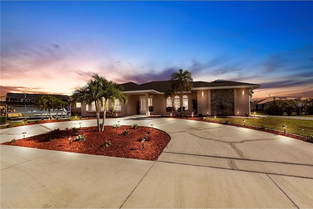 20339 Gentry Ave, Port Charlotte, FL 33952 - view of front of house with stucco siding and curved driveway
