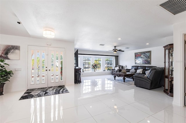 20339 Gentry Ave, Port Charlotte, FL 33952 - foyer entrance with tile patterned floors, french doors, a textured ceiling, visible vents, and ceiling fan
