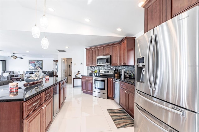 20339 Gentry Ave, Port Charlotte, FL 33952 - kitchen featuring tasteful backsplash, open floor plan, a ceiling fan, appliances with stainless steel finishes, and hanging light fixtures