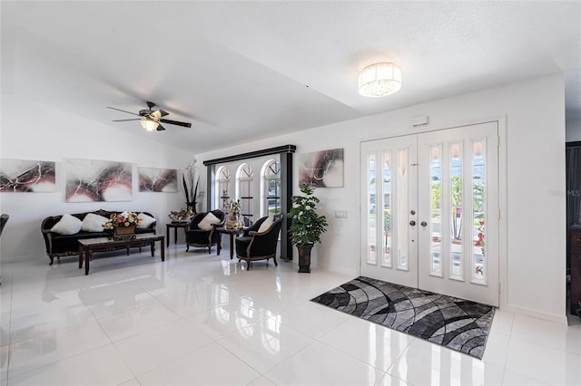20339 Gentry Ave, Port Charlotte, FL 33952 - tiled entrance foyer featuring baseboards, a ceiling fan, and lofted ceiling