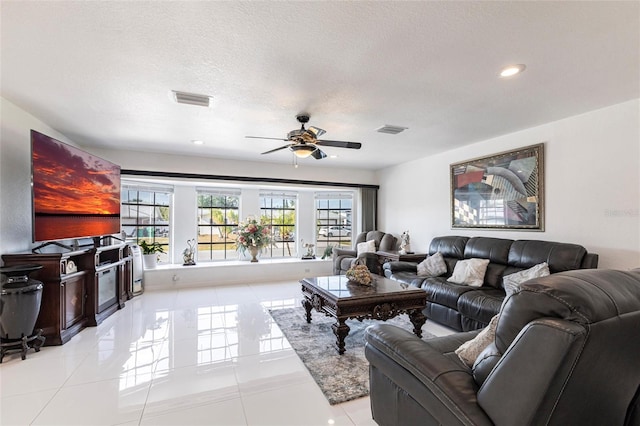 20339 Gentry Ave, Port Charlotte, FL 33952 - living area with visible vents, ceiling fan, light tile patterned flooring, and a textured ceiling