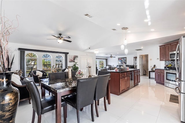 20339 Gentry Ave, Port Charlotte, FL 33952 - dining space featuring wine cooler, visible vents, ceiling fan, and vaulted ceiling