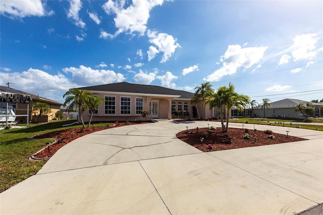 20339 Gentry Ave, Port Charlotte, FL 33952 - single story home with stucco siding, a front lawn, and curved driveway