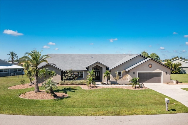 view of front facade with a garage, concrete driveway, and a front lawn