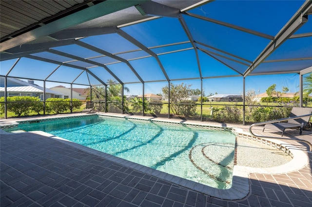 outdoor pool featuring a residential view, glass enclosure, and a patio