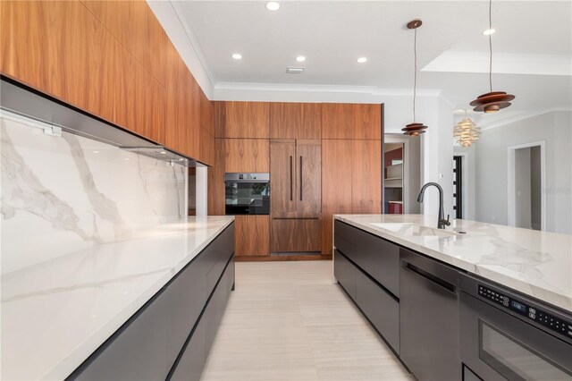 kitchen with modern cabinets, light stone counters, brown cabinets, oven, and a sink