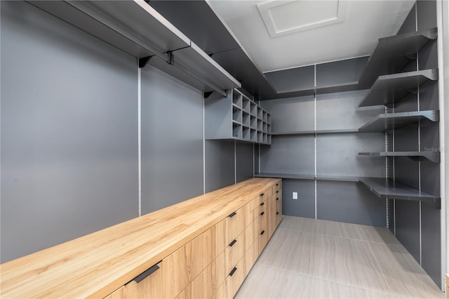 walk in closet featuring light tile patterned floors