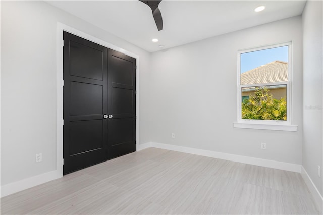 unfurnished bedroom with a ceiling fan, recessed lighting, and baseboards