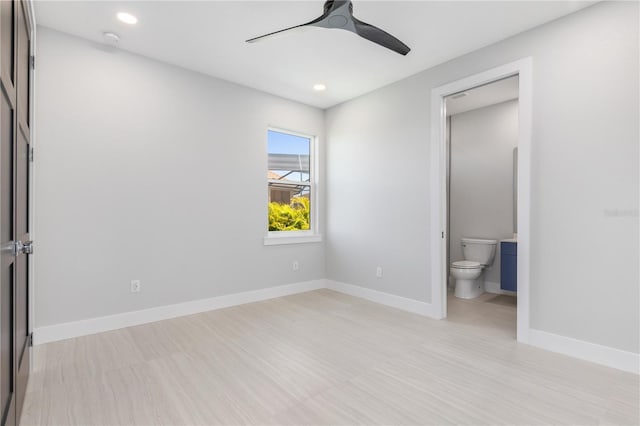 unfurnished bedroom with ensuite bath, baseboards, a ceiling fan, and recessed lighting