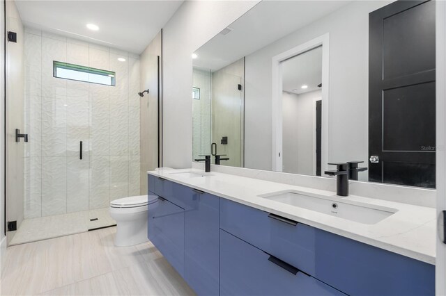 full bathroom featuring a stall shower, a sink, and toilet