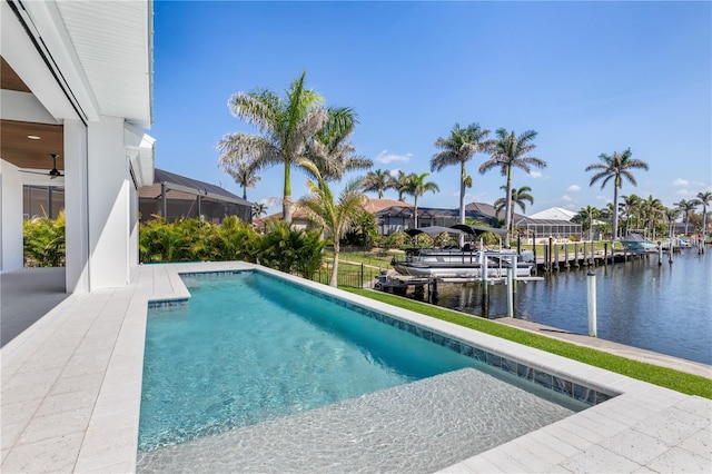 pool featuring a dock, glass enclosure, a water view, and boat lift