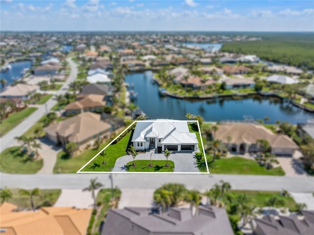 birds eye view of property with a residential view and a water view