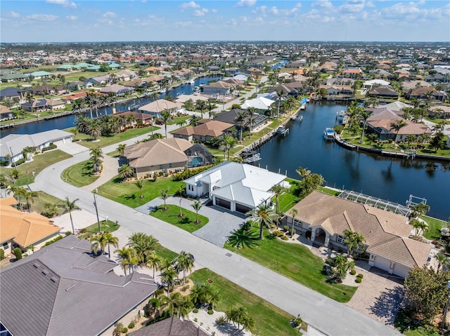 birds eye view of property with a water view and a residential view