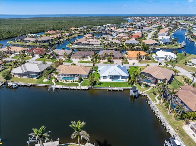 birds eye view of property featuring a water view and a residential view