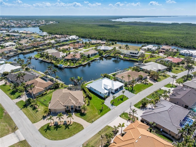 birds eye view of property featuring a water view and a residential view