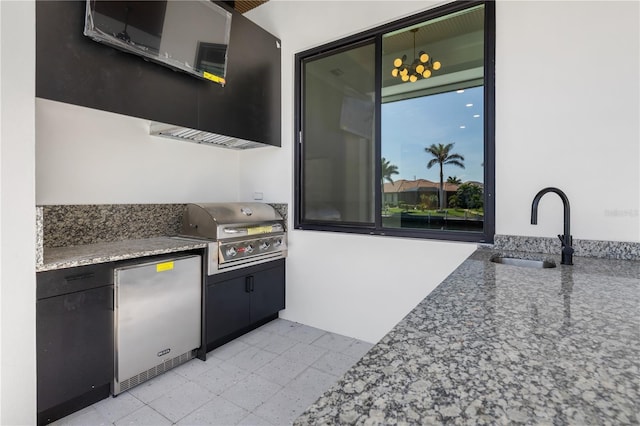 view of patio / terrace featuring exterior kitchen, a grill, and a sink