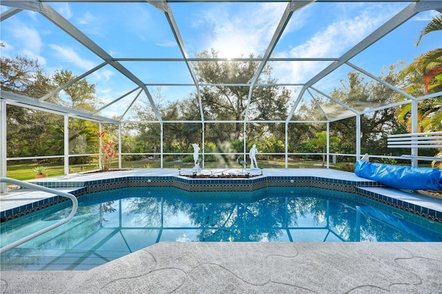 pool featuring glass enclosure and a patio