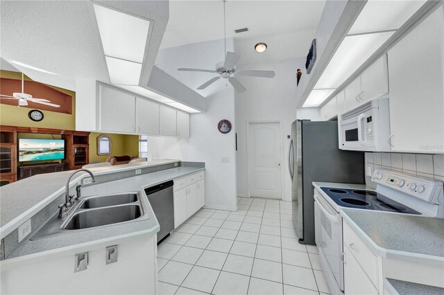 kitchen with white appliances, a sink, a ceiling fan, and white cabinetry