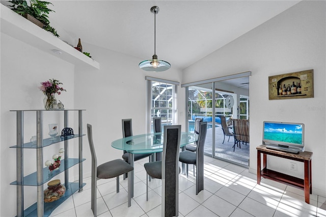 dining space featuring lofted ceiling, a sunroom, and light tile patterned floors