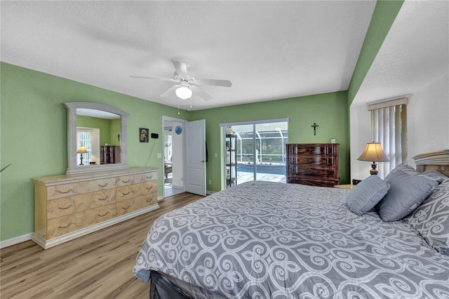 bedroom featuring access to exterior, ceiling fan, baseboards, and wood finished floors