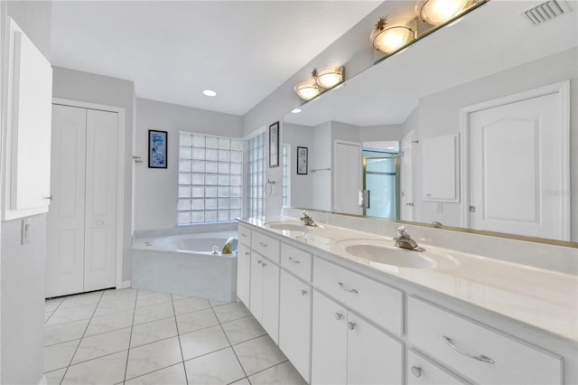 full bathroom with a bath, a closet, visible vents, and a sink