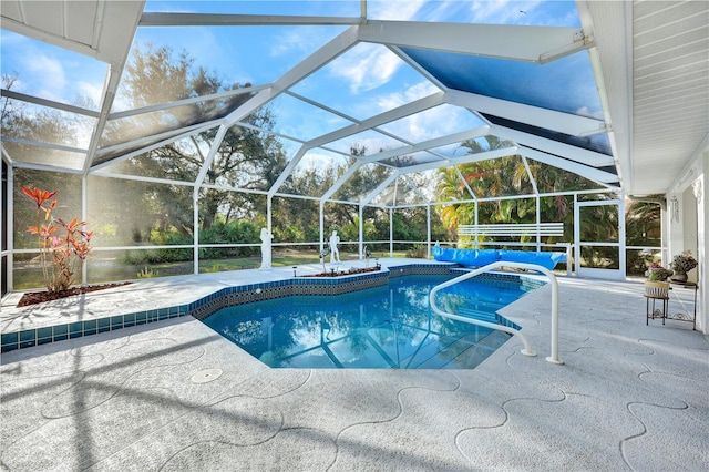 outdoor pool featuring a patio area and glass enclosure