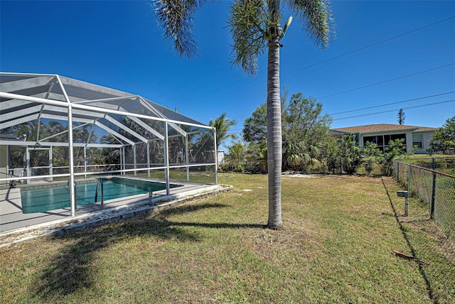 outdoor pool featuring a lawn, glass enclosure, and fence