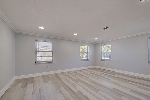 unfurnished room with crown molding, baseboards, and visible vents