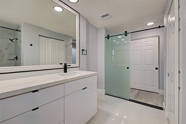 bathroom with recessed lighting, visible vents, vanity, and a shower stall