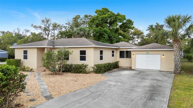 single story home featuring a garage and driveway