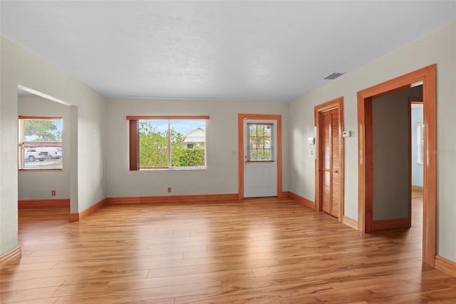 interior space with light wood-style floors, visible vents, and baseboards